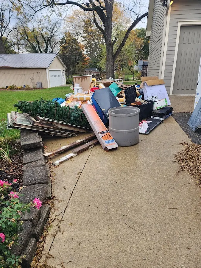 Dumpster being loaded with debris for Estate Cleanout Dumpster Rental in Warrenville
